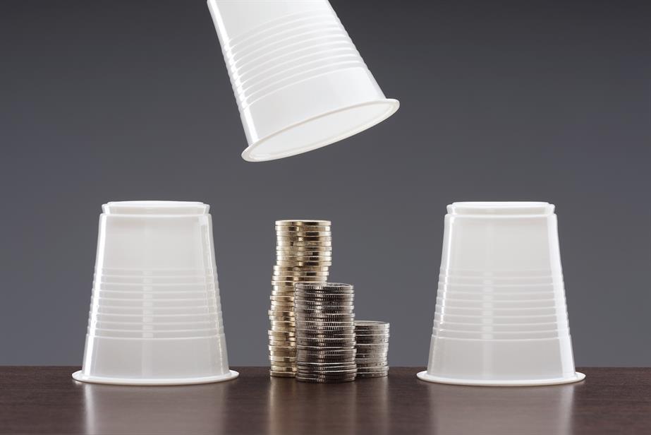 upturned cups hiding piles of coins