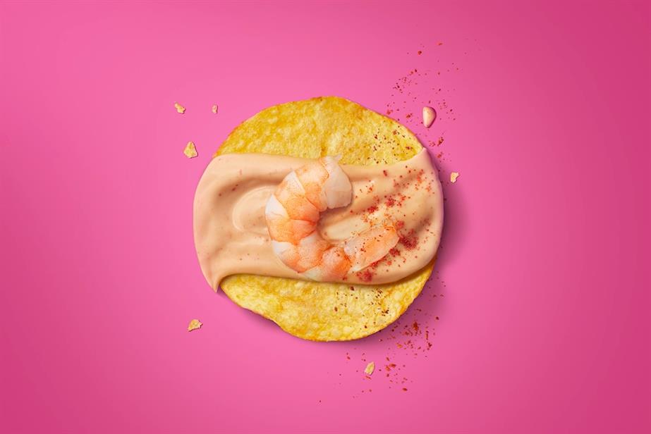 A crisp with a prawn and prawn cocktail sauce on top of it.