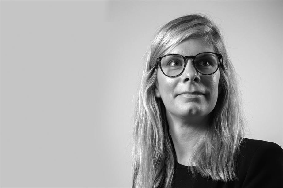 Black and white photo of blonde woman wearing glasses
